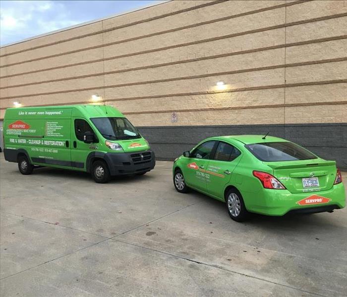 Two green SERVPRO vehicles