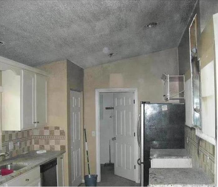 Kitchen walls and ceiling covered with smoke